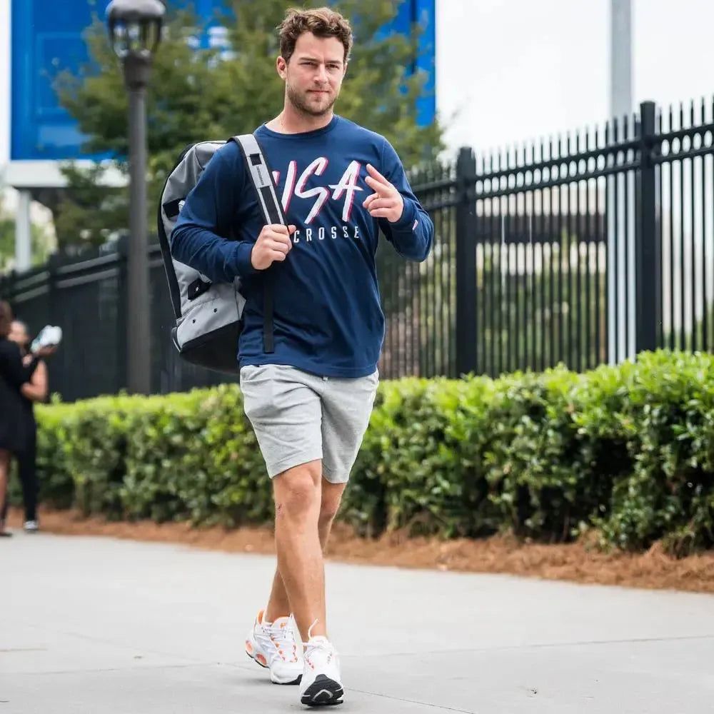 Navy long-sleeve shirt with USA Lacrosse in bold white and red letters.