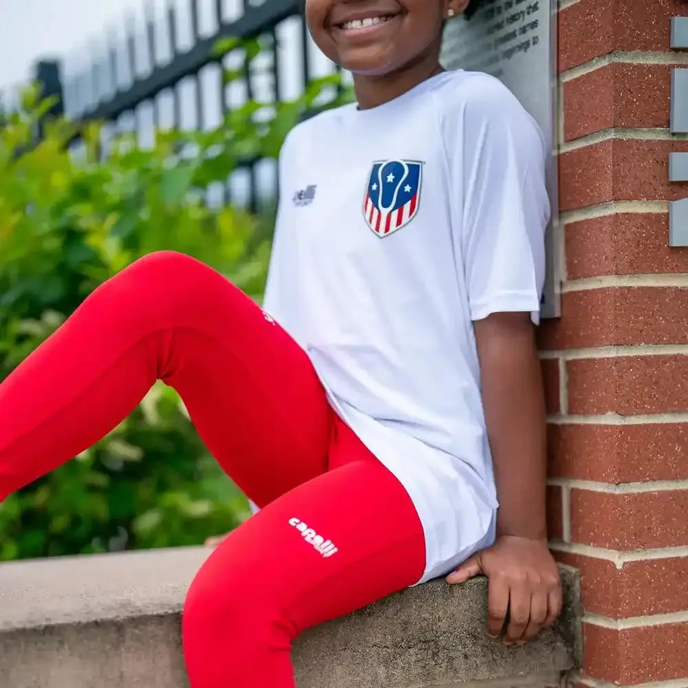 Red athletic leggings with black waistband and logos.