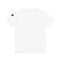 White t-shirt with a small flag on the sleeve.